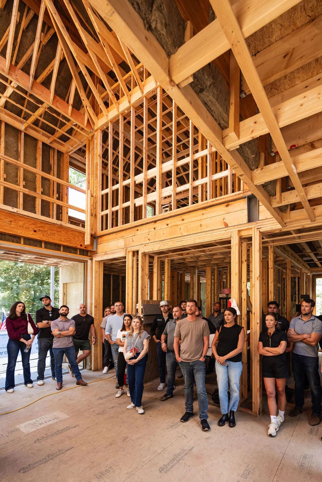 Contractors touring an active job site framing